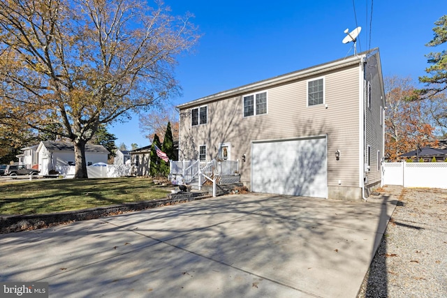 rear view of house with a yard and a garage