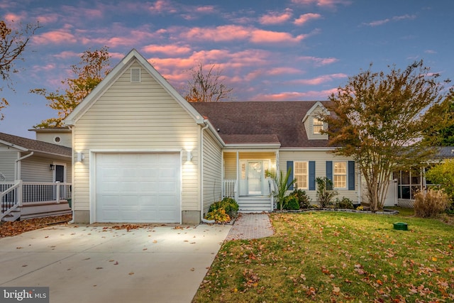 view of front facade with a yard and a garage