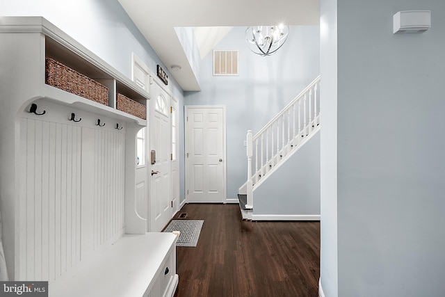 mudroom featuring dark hardwood / wood-style flooring and a chandelier