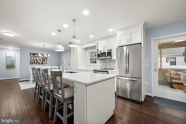 13801 Fountain Rd, Ocean City, MD 21842 - kitchen with stainless steel appliances, dark wood-type flooring, white cabinets, decorative backsplash, and recessed lighting