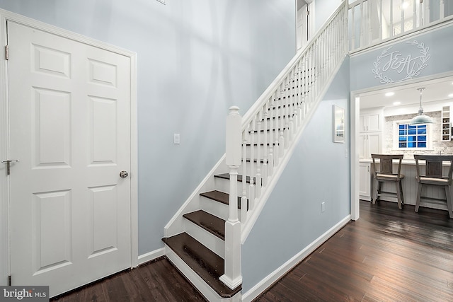 13801 Fountain Rd, Ocean City, MD 21842 - staircase with wood finished floors, baseboards, and a towering ceiling