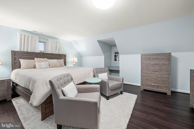 bedroom featuring dark wood-type flooring and lofted ceiling