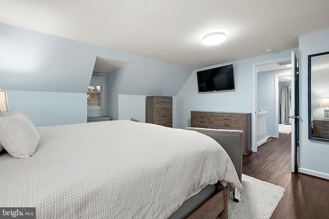 bedroom featuring vaulted ceiling and dark wood-type flooring