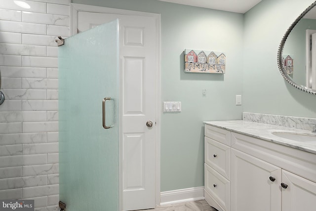 bathroom featuring vanity and a shower with shower door