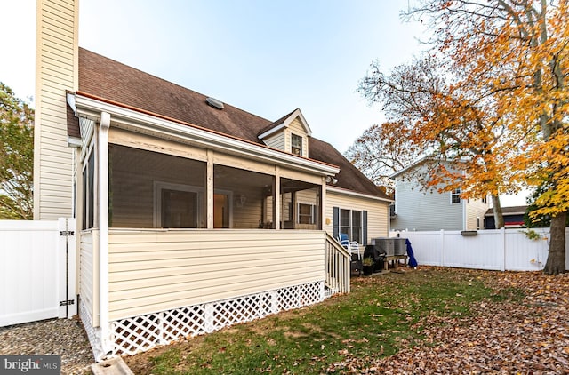 13801 Fountain Rd, Ocean City, MD 21842 - rear view of property featuring a shingled roof, a sunroom, and a chimney