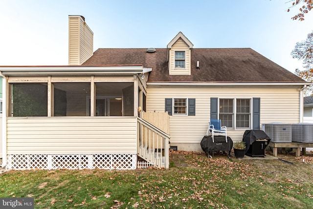 13801 Fountain Rd, Ocean City, MD 21842 - rear view of property featuring a lawn, a chimney, central AC, a shingled roof, and a sunroom