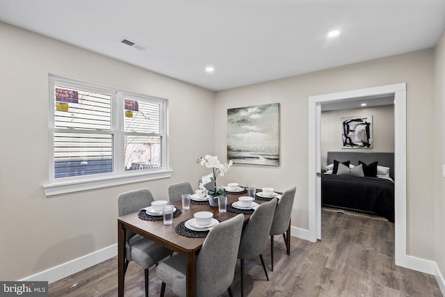 dining space featuring wood-type flooring