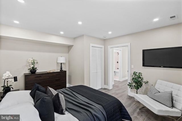 bedroom featuring light wood-type flooring and a closet