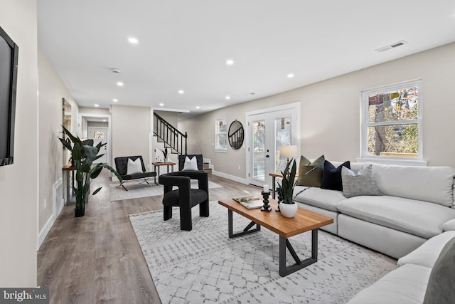 living room featuring french doors and light hardwood / wood-style floors