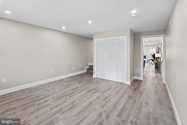 unfurnished bedroom featuring a closet and light hardwood / wood-style flooring