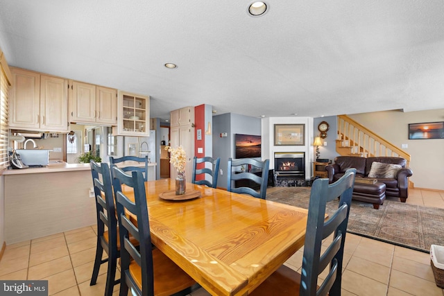 dining room with light tile patterned floors and a textured ceiling