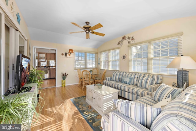 living room with light hardwood / wood-style flooring, ceiling fan, and lofted ceiling