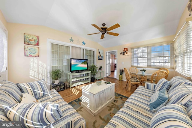 living room with light wood-type flooring, vaulted ceiling, and ceiling fan