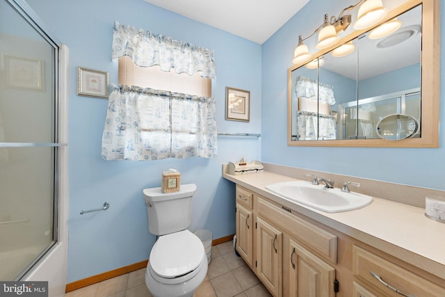 full bathroom featuring combined bath / shower with glass door, tile patterned floors, vanity, and toilet