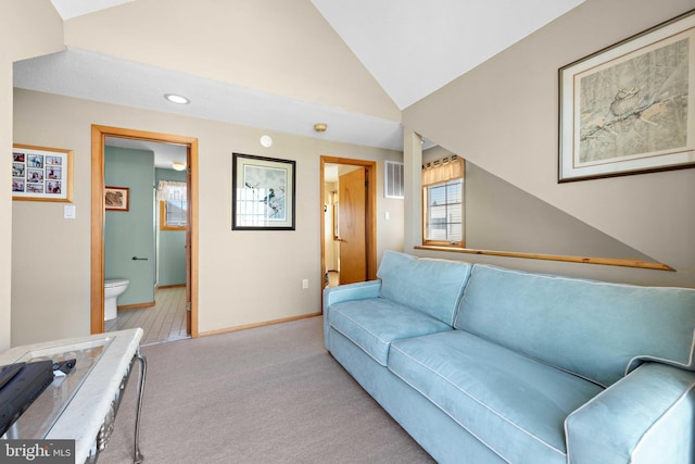 carpeted living room with vaulted ceiling