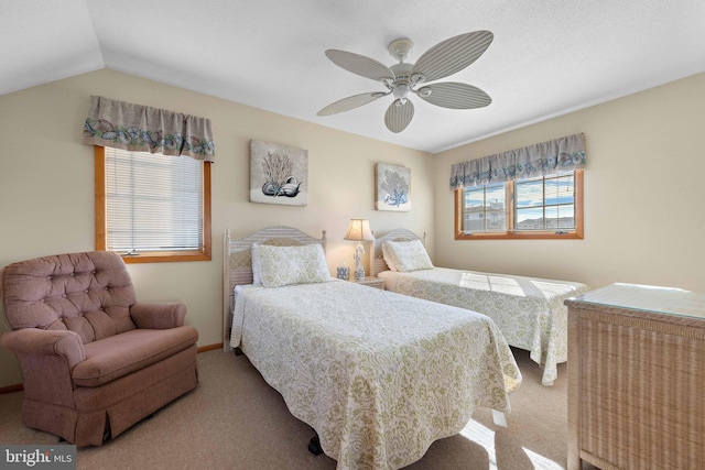 bedroom featuring multiple windows, ceiling fan, light colored carpet, and lofted ceiling