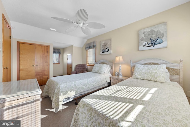 carpeted bedroom featuring ceiling fan, lofted ceiling, and a closet