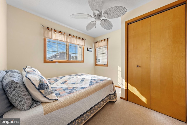 bedroom featuring carpet, a closet, and ceiling fan