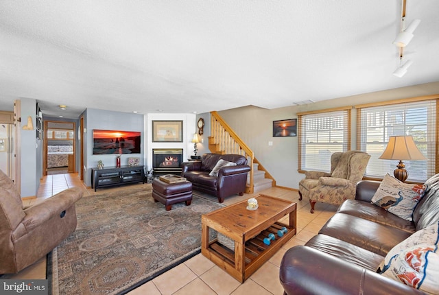 living room featuring light tile patterned floors and a textured ceiling