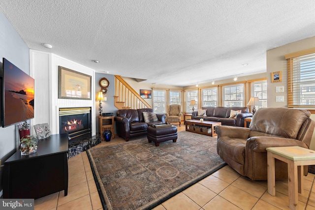 living room with light tile patterned flooring and a textured ceiling