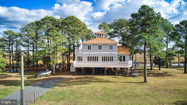 rear view of house featuring a yard and a wooden deck