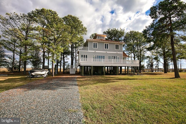 beach home with a carport and a front lawn