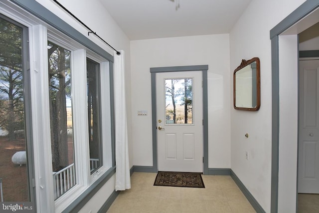 doorway featuring light tile patterned flooring