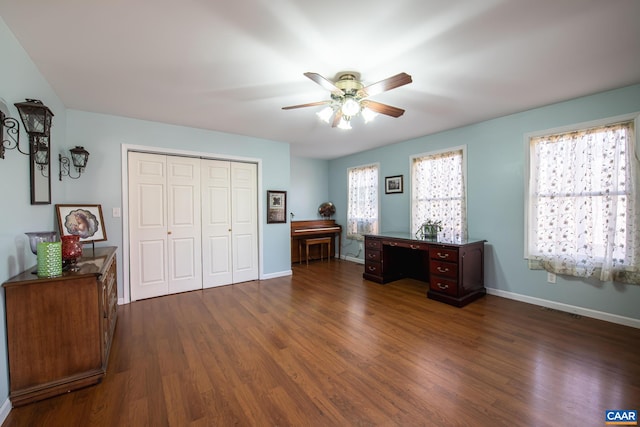 bedroom featuring a closet, dark hardwood / wood-style floors, and ceiling fan