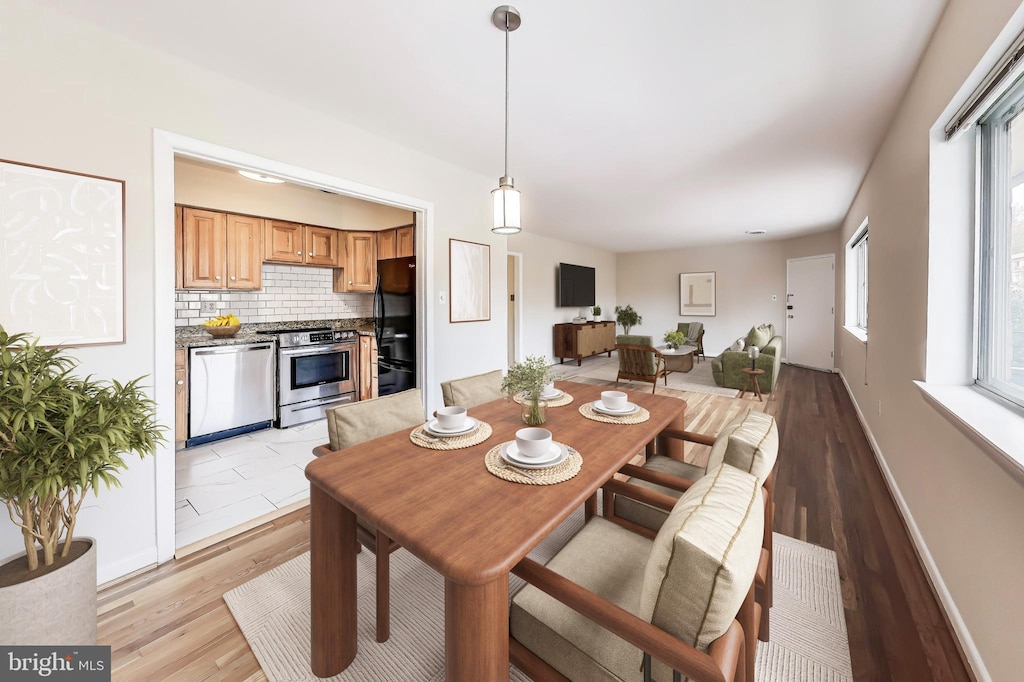 dining space with light wood-type flooring