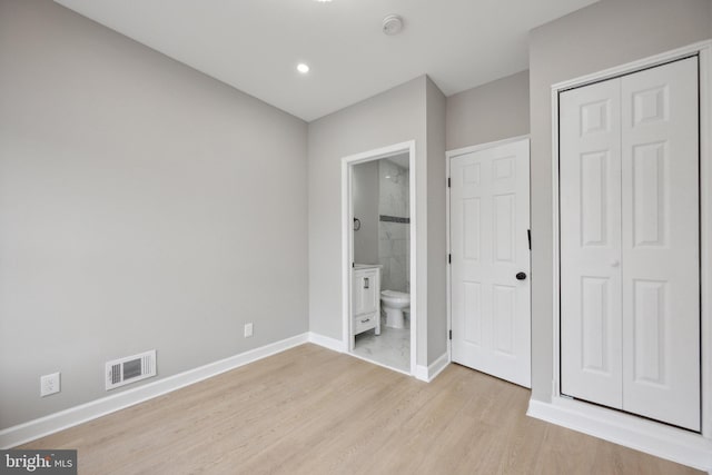 1155 Washington Blvd, Baltimore, MD 21230 - unfurnished bedroom featuring light wood finished floors, baseboards, a closet, ensuite bathroom, and recessed lighting