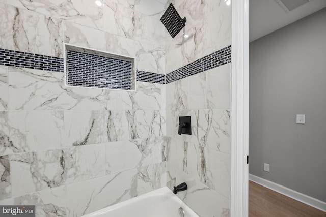 1155 Washington Blvd, Baltimore, MD 21230 - bathroom featuring shower / washtub combination, baseboards, and wood finished floors