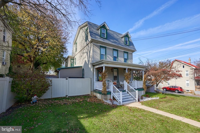 view of front facade with covered porch and a front lawn