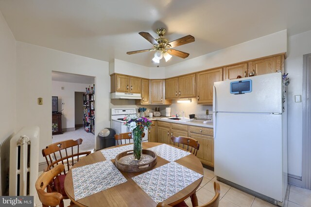 kitchen featuring ceiling fan, light tile patterned flooring, white appliances, and sink