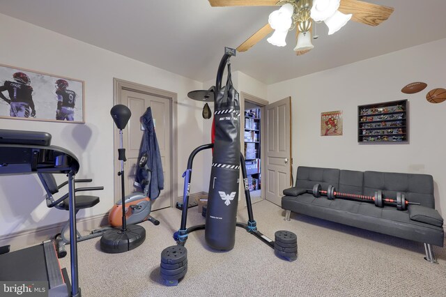 exercise room with ceiling fan and carpet floors