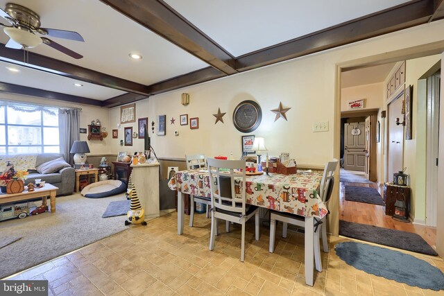 dining area with beam ceiling and ceiling fan