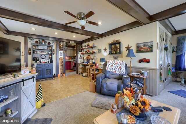 living room with beam ceiling, ceiling fan, and light carpet