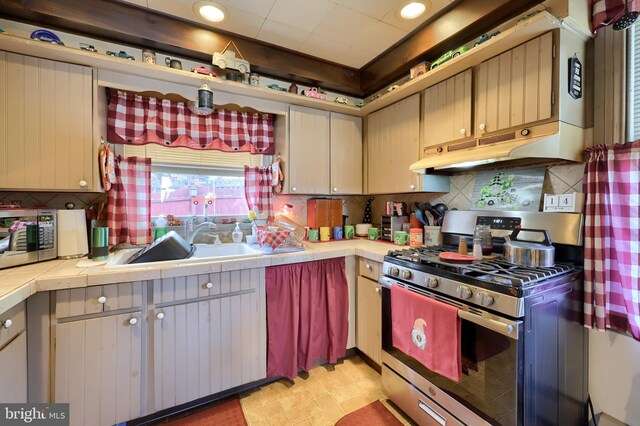 kitchen featuring tile countertops, sink, and stainless steel appliances