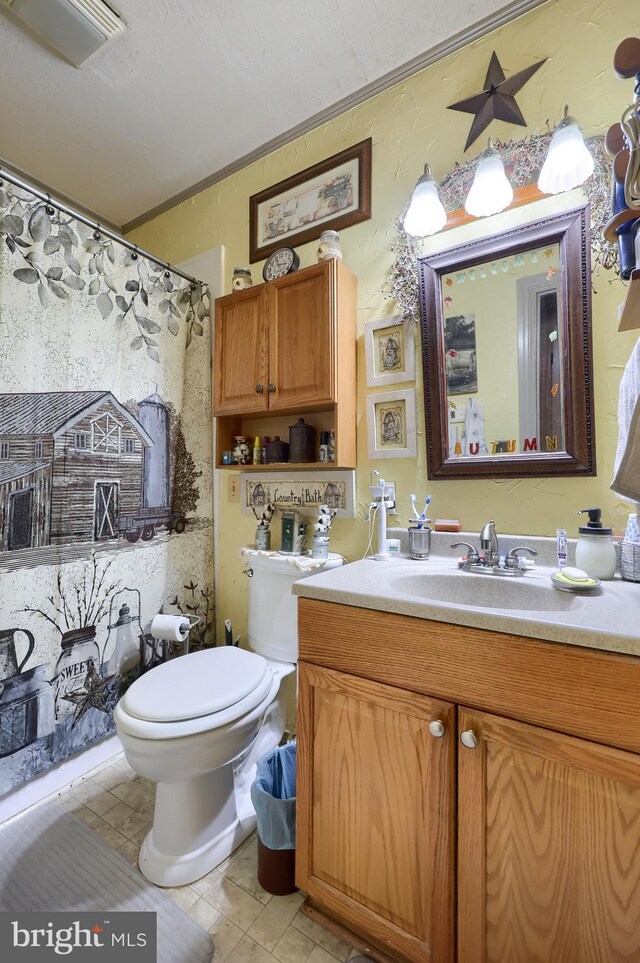 bathroom featuring toilet, vanity, tile patterned floors, and walk in shower