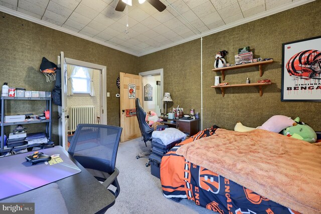 carpeted bedroom with radiator, ceiling fan, and crown molding