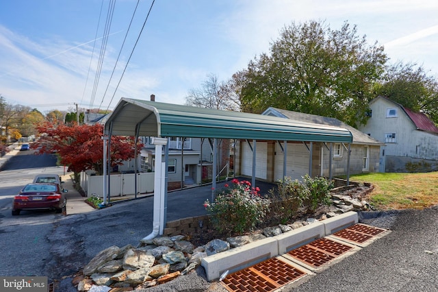 view of front of property featuring a garage and a carport