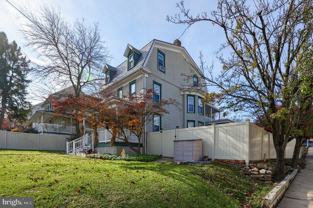 view of side of home featuring a lawn