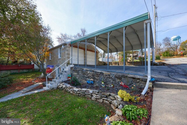 exterior space with a garage and a carport