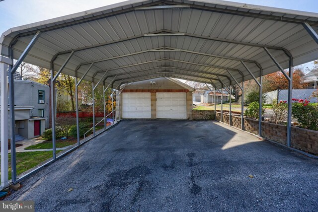 view of vehicle parking with a garage and a carport