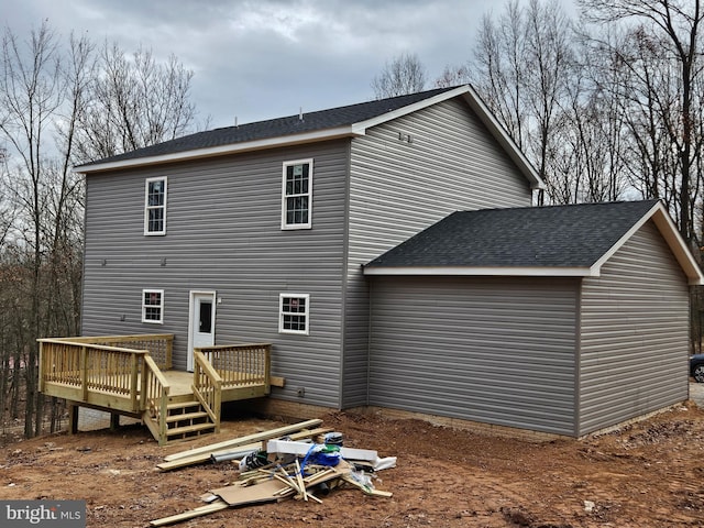 back of house featuring a wooden deck