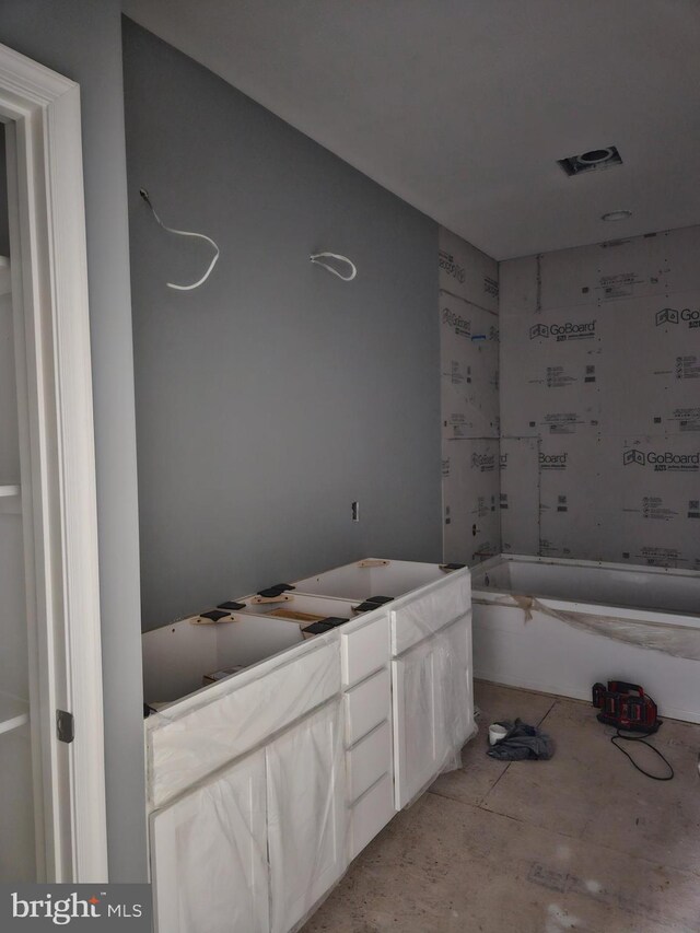 bathroom featuring a tub to relax in and vanity