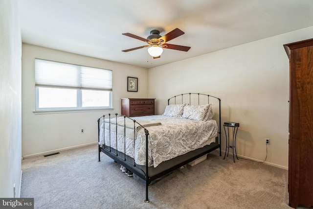 bedroom featuring ceiling fan and light carpet