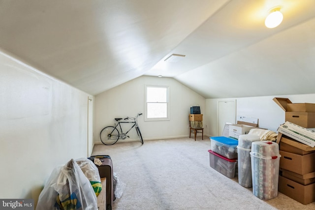 additional living space with vaulted ceiling and light colored carpet