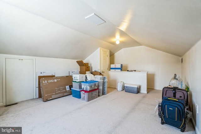 bonus room featuring vaulted ceiling and carpet flooring