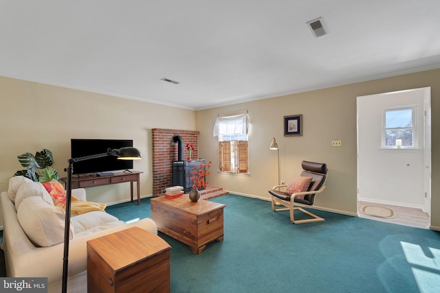 carpeted living room featuring a wood stove and crown molding