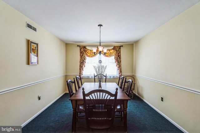 dining space with dark carpet and an inviting chandelier